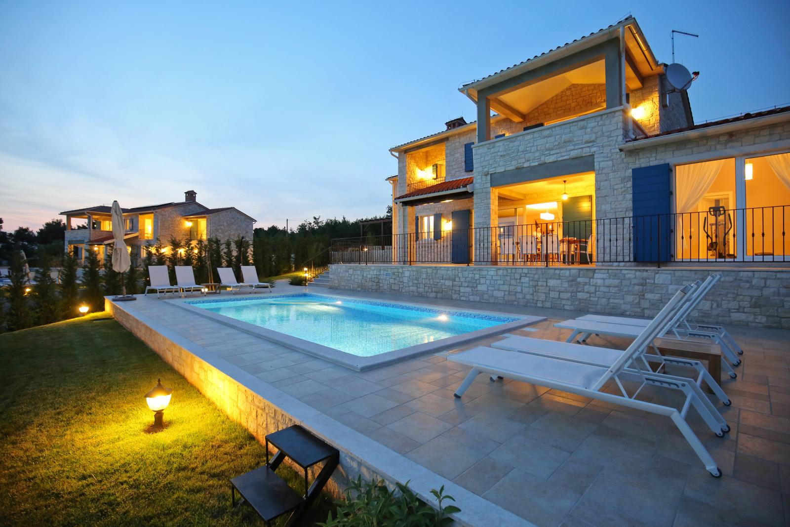 Villa Babudri and its private pool lit up at dusk